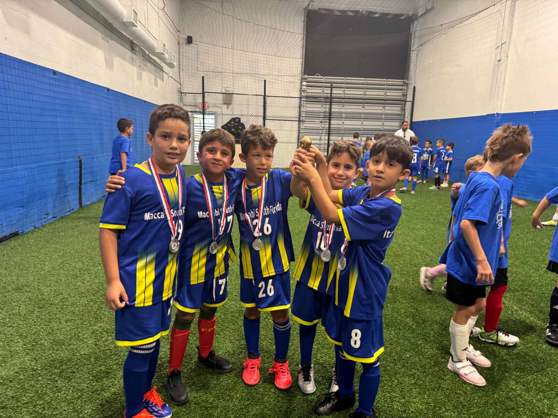 Kids soccer training Hollywood Florida — young Maccabi South Florida players in blue and gold on the field
